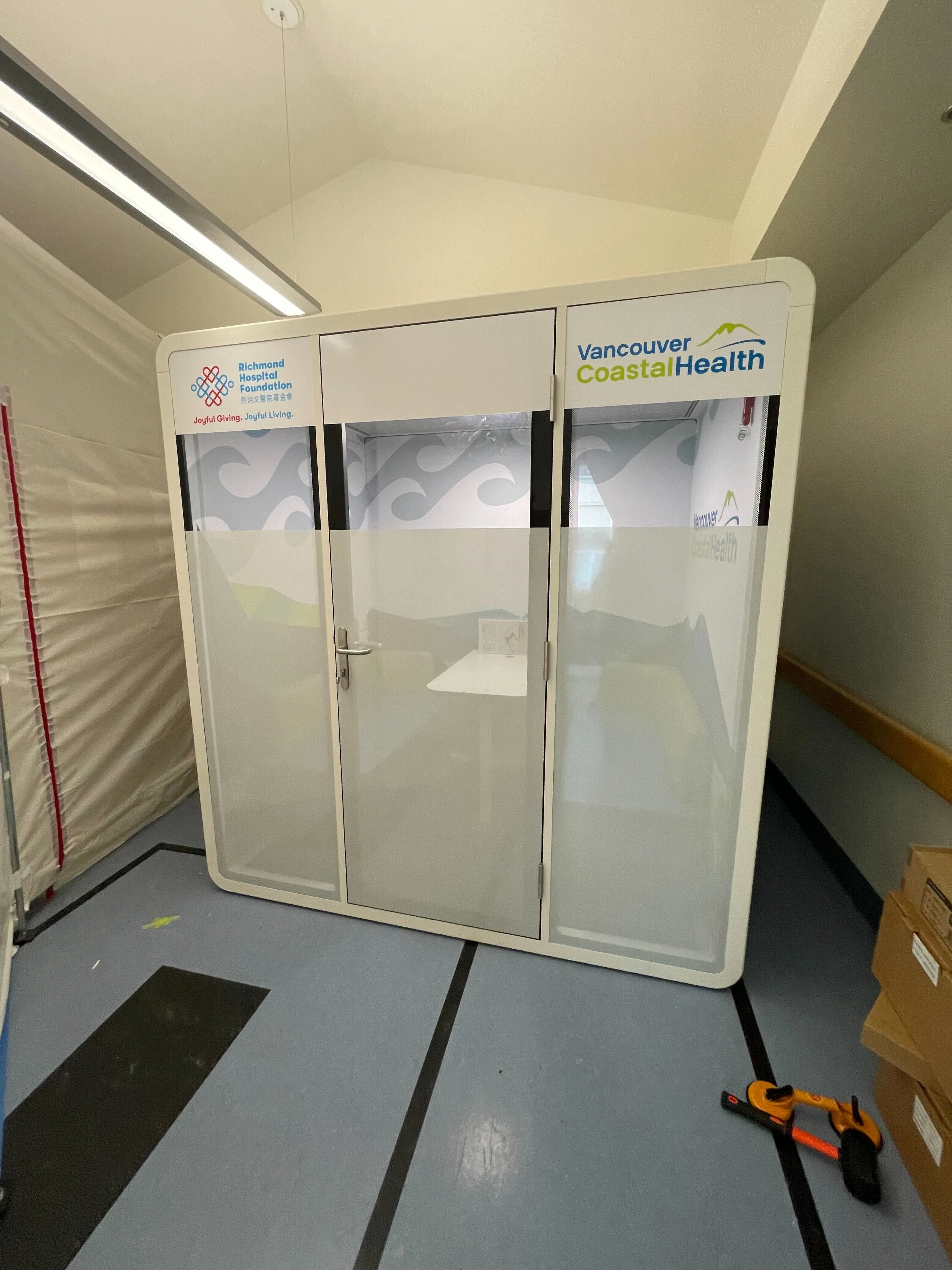 A real Bureau booth custom-decaled for Richmond Hospital Foundation and Vancouver Coastal Health, installed in a hospital corridor