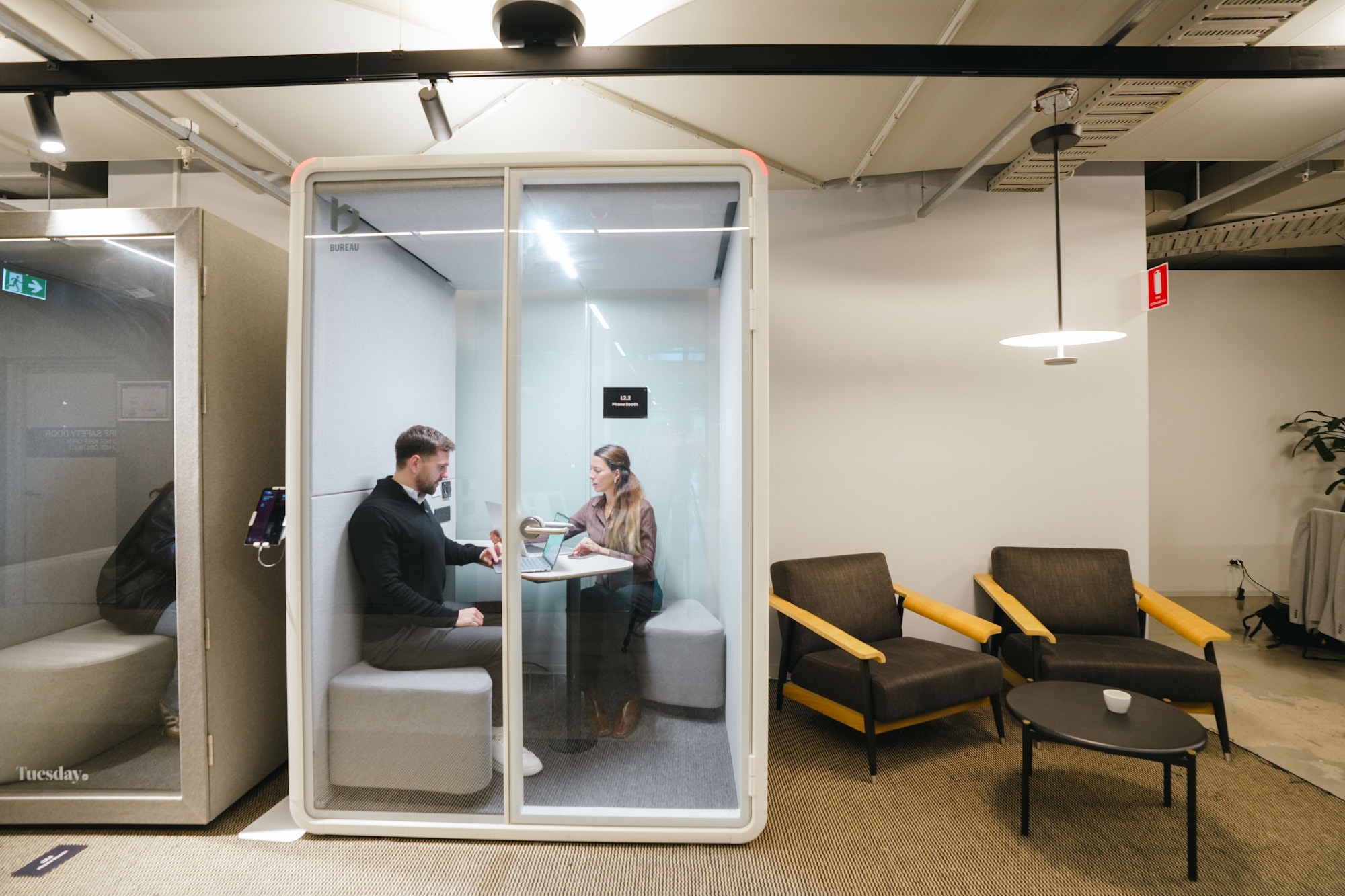 Meeting inside a Bureau booth at the Sydney showroom